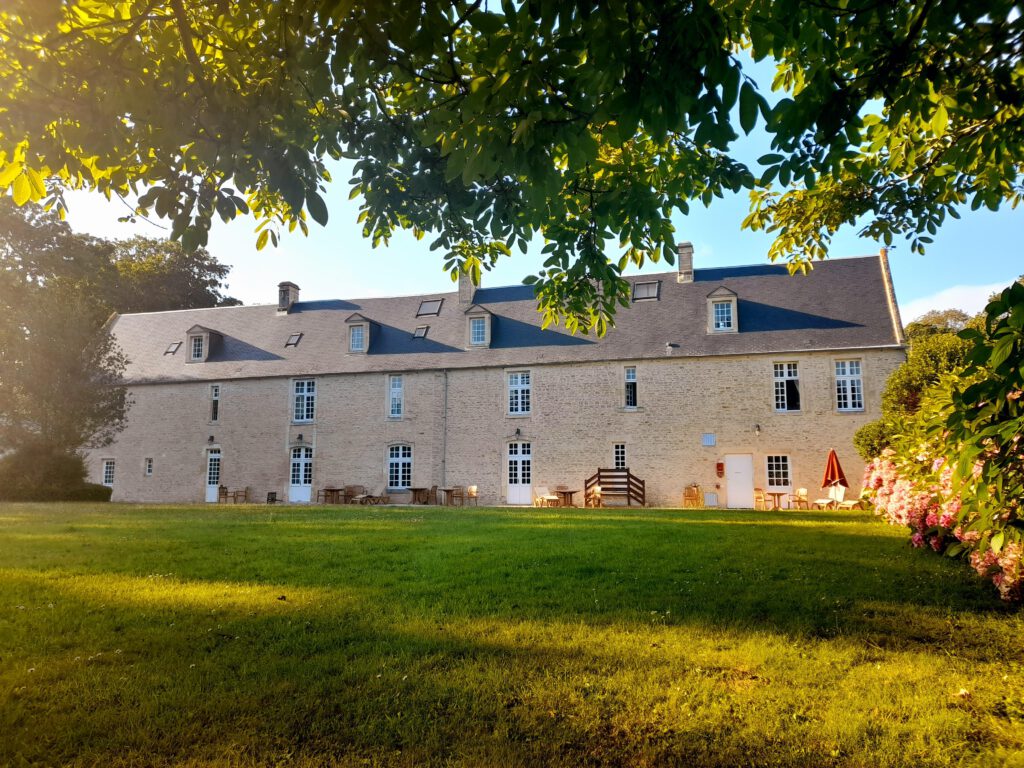 Udsigt til Mathan Manor med sine stenvægge, grønne have og udendørs møbler, der tilbyder en fredelig atmosfære.